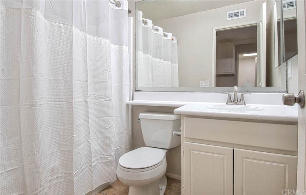 83 Sapphire, Unit 46 Irvine, CA 92602 - Photo 13 of 18 a bathroom with a sink a toilet and a mirror