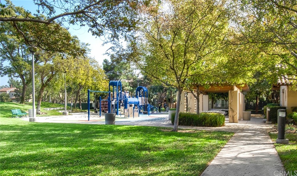 83 Sapphire, Unit 46 Irvine, CA 92602 - Photo 17 of 18 a front view of a building with a garden