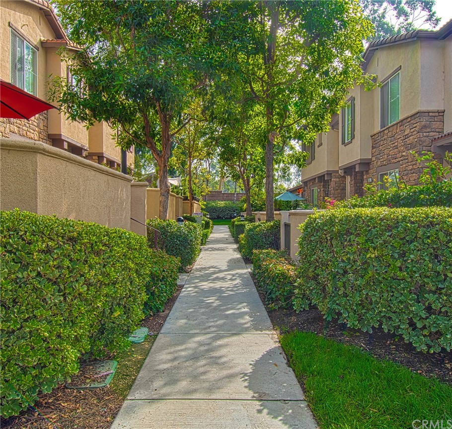 83 Sapphire, Unit 46 Irvine, CA 92602 - Photo 18 of 18 a view of a pathway with house on both side