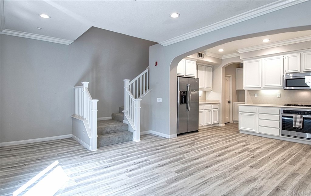 83 Sapphire, Unit 46 Irvine, CA 92602 - Photo 8 of 18 a view of a kitchen with wooden floor and electronic appliances