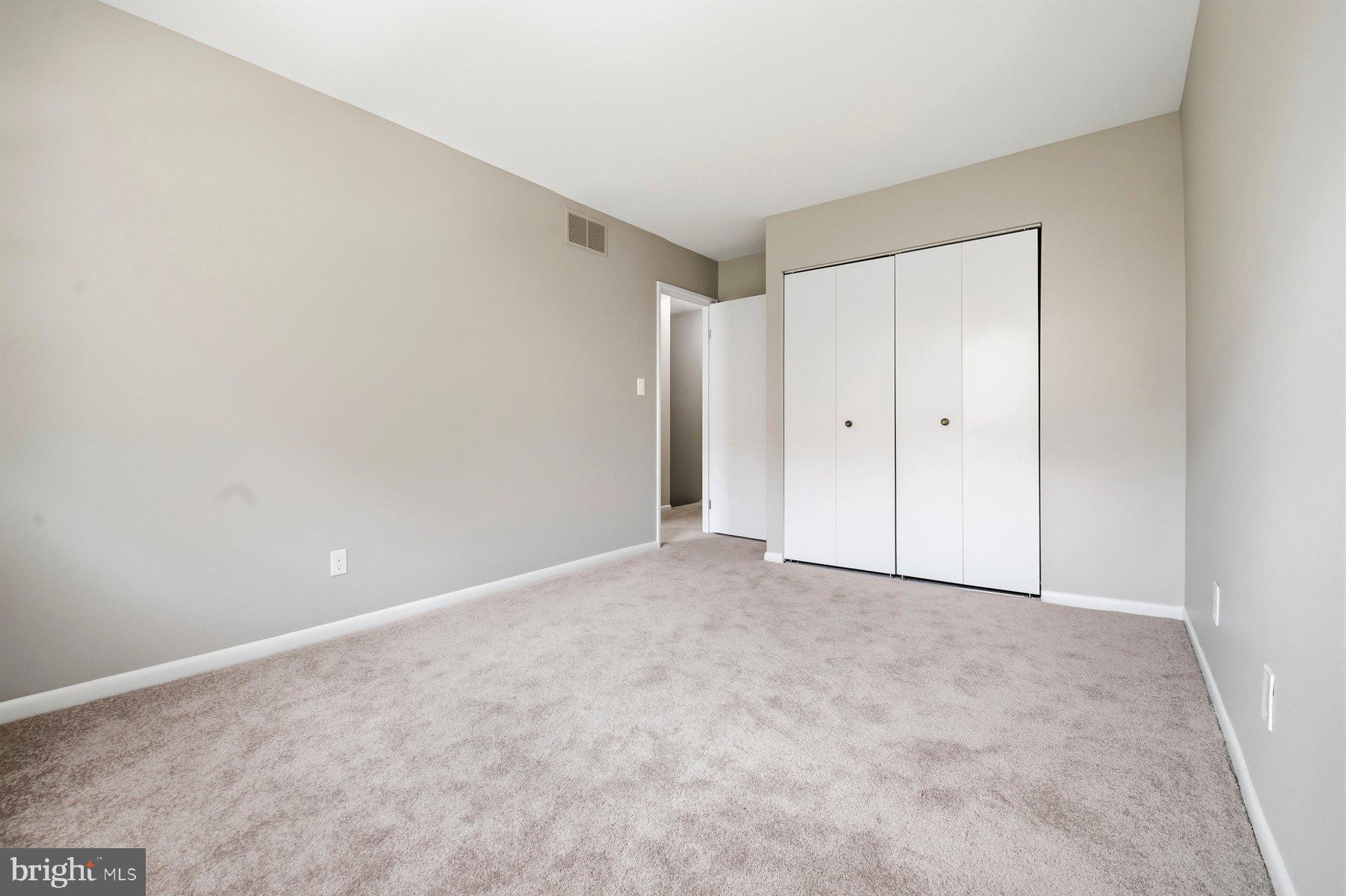 9080 Moonshine Hollow, Unit F Laurel, MD 20723 - Photo 16 of 24 Spacious room with neutral tones.