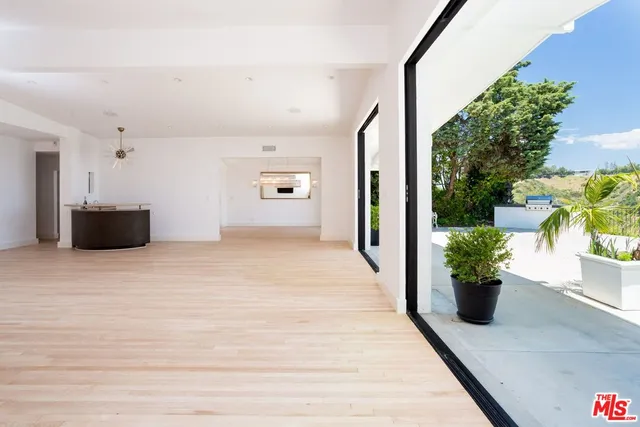 a view of a big room with wooden floor and a window