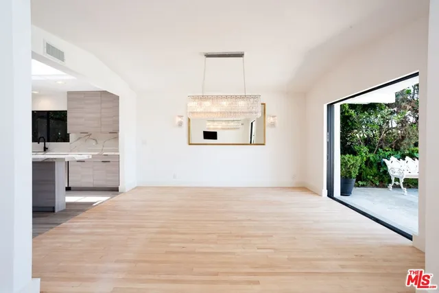 a view of a room with wooden floor and windows