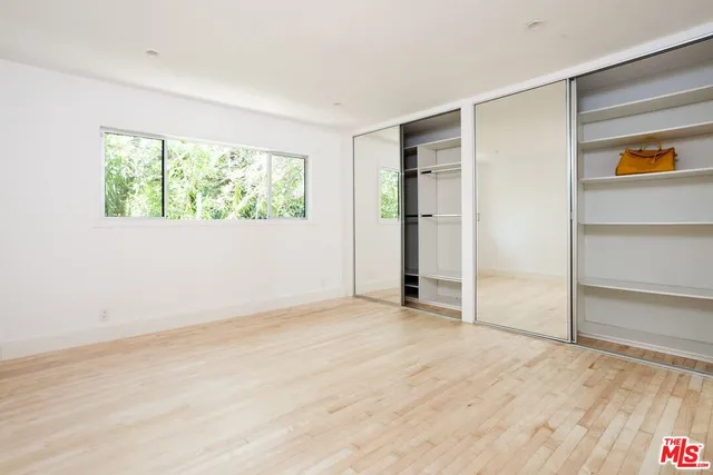 a view of a livingroom with wooden floor and a flat screen tv