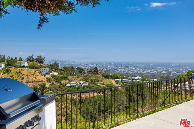 a park view with a bench and lake view