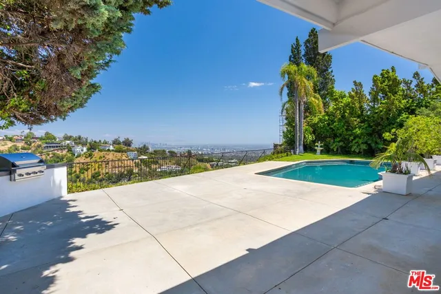 a living room with furniture a rug and a large window