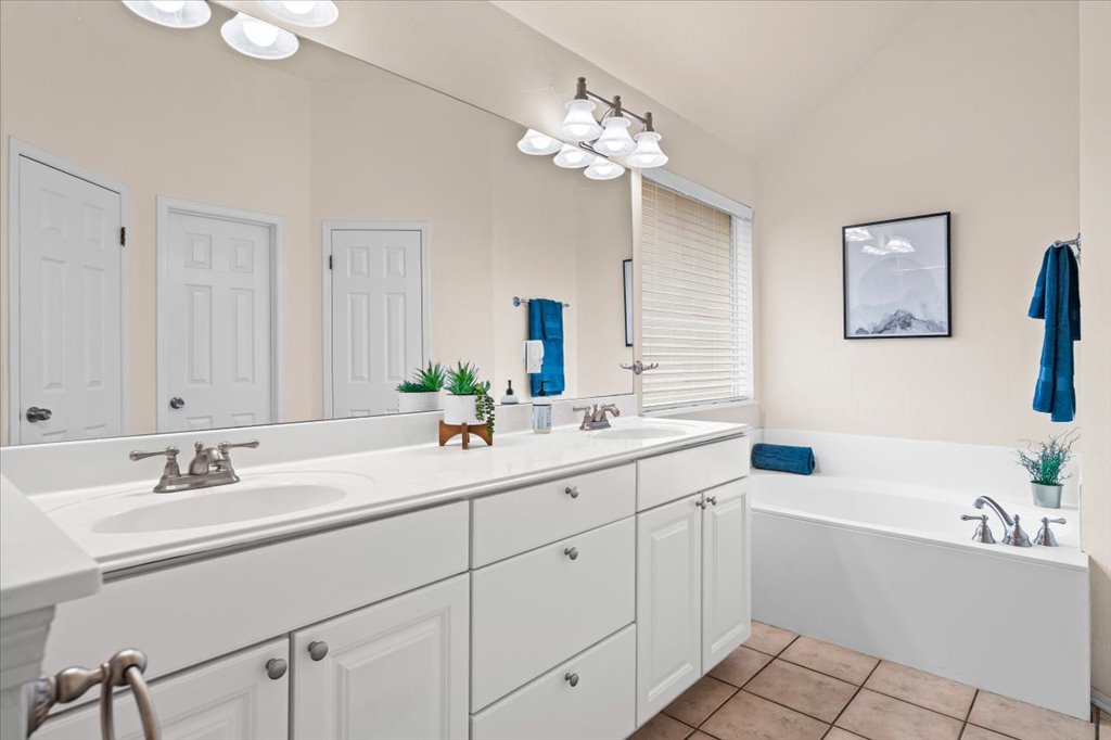 8111 Davis Mountain Pass Austin, TX 78726 - Photo 16 of 37 a bathroom with a sink double vanity granite tub and a mirror