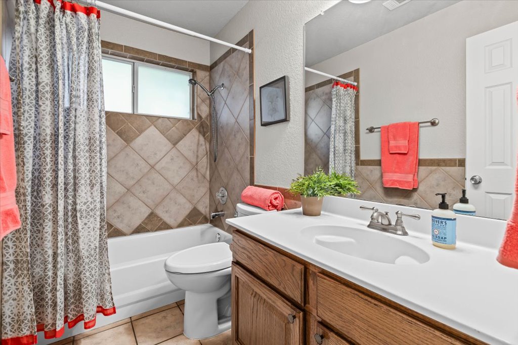 8111 Davis Mountain Pass Austin, TX 78726 - Photo 19 of 37 a bathroom with a sink vanity granite toilet and shower