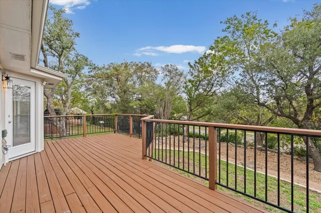 a balcony with wooden floor and fence