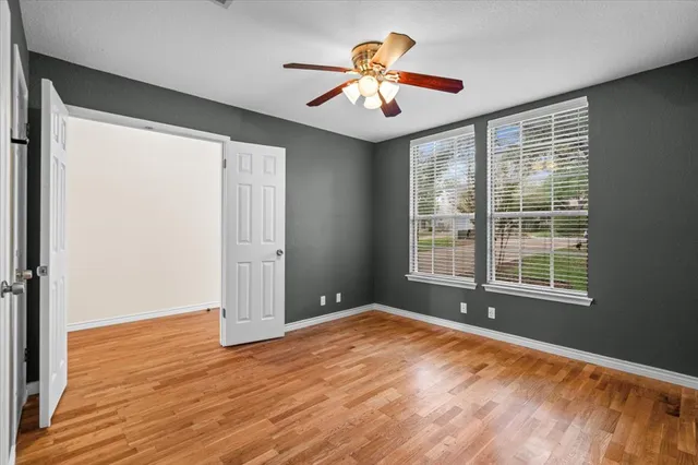 a view of a kitchen with wooden floor and a window