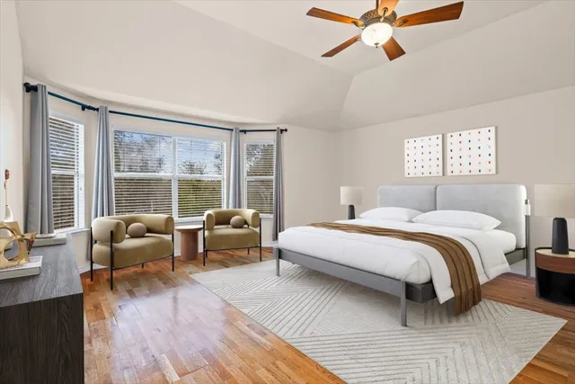 a spacious bedroom with a bed and a large window