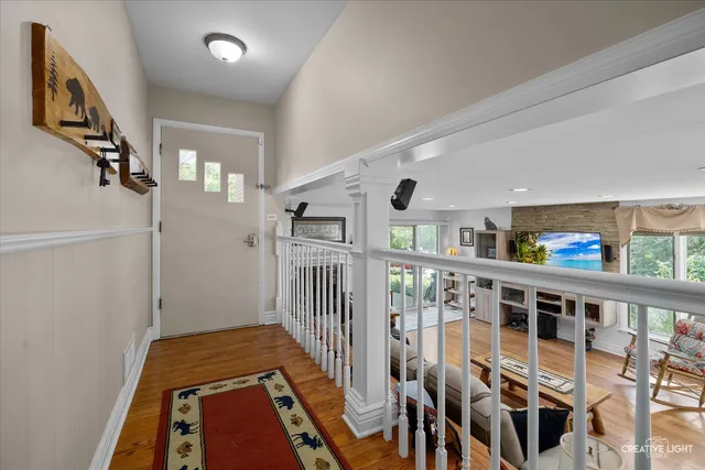 a view of a hallway with wooden floor and entryway