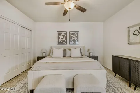 a bedroom with a bed and a chandelier