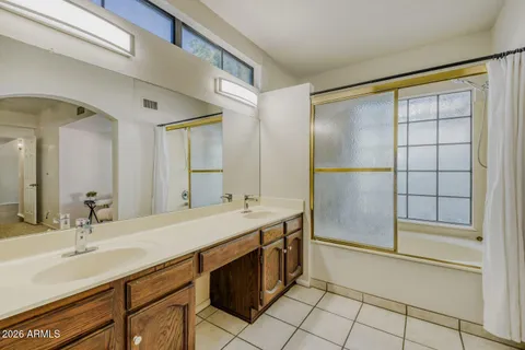 a bathroom with a shower sink vanity and mirror