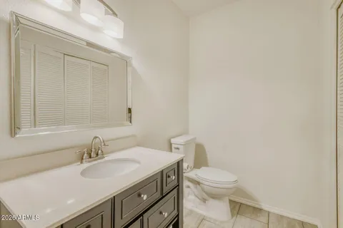 a bathroom with a sink a toilet and a mirror