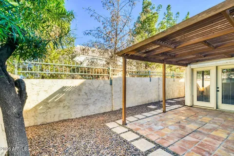 a view of a house with backyard and a tree