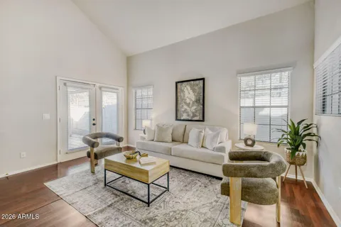 a living room with furniture potted plant and windows