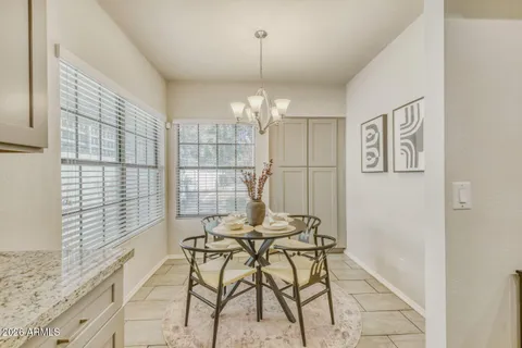 a view of a dining room with furniture and chandelier