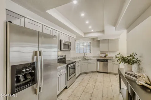 a kitchen with a sink stainless steel appliances and cabinets