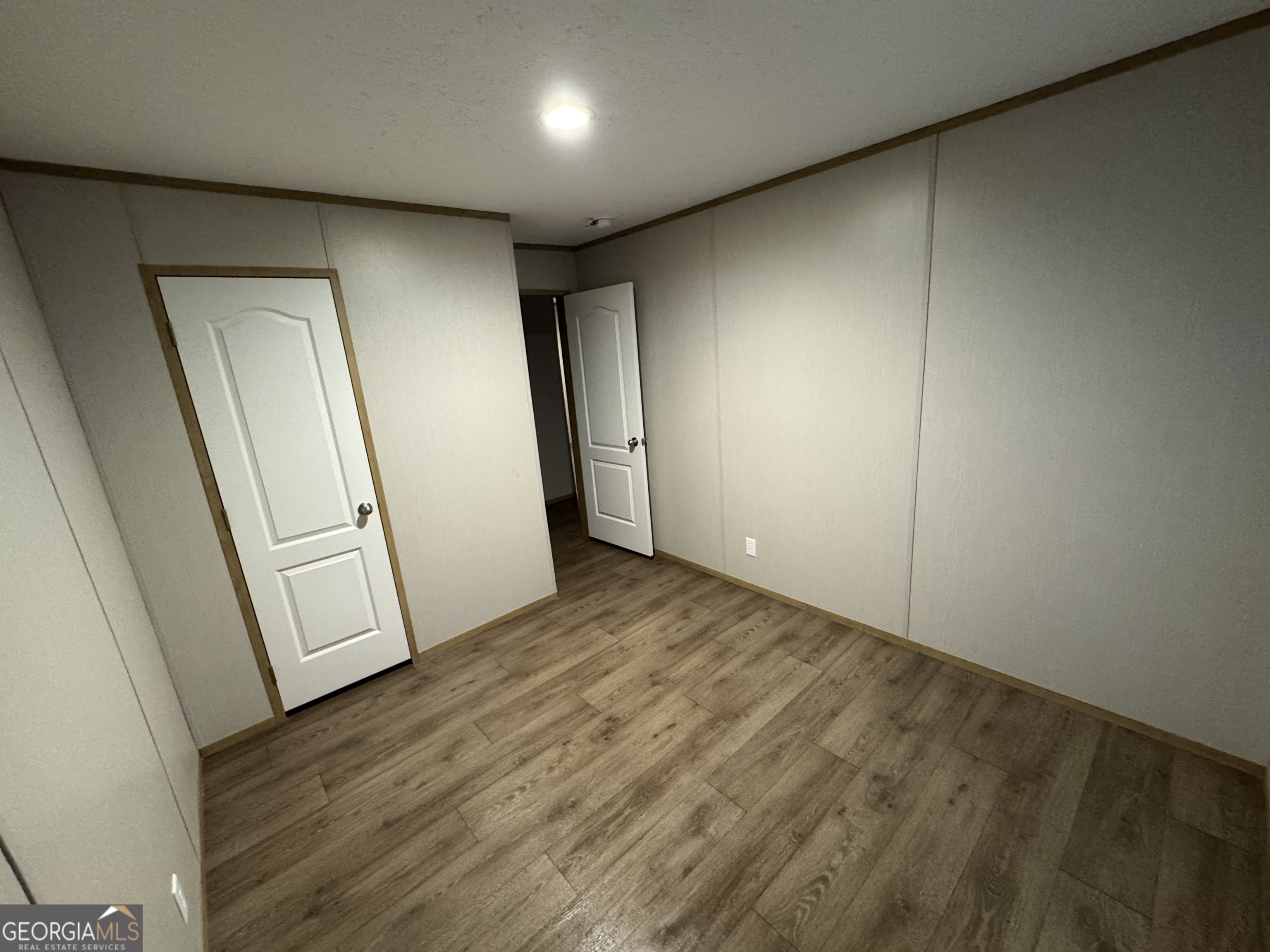 215 Poplar Circle West Point, GA 31833 - Photo 12 of 15 an empty room with wooden floor and window