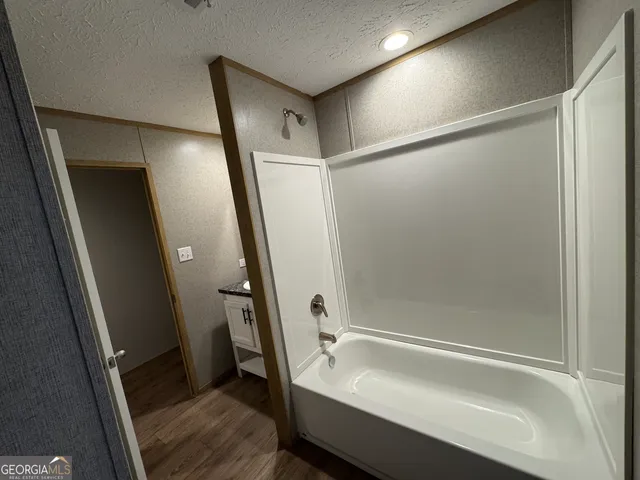 a bathroom with a tub and sink
