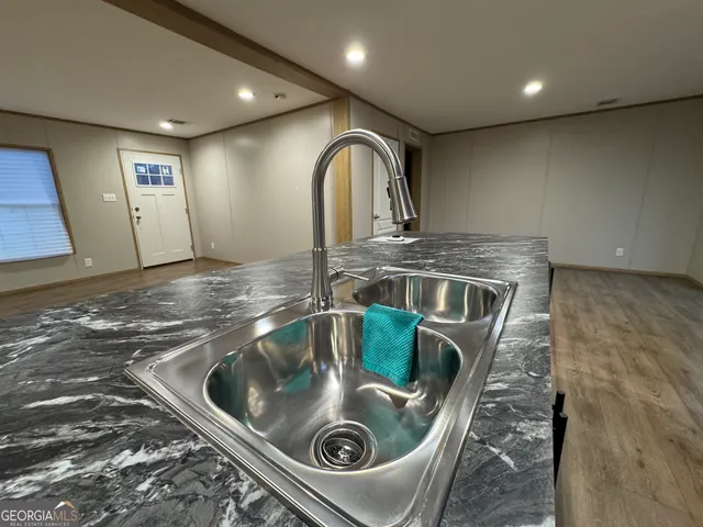 a kitchen with stainless steel appliances granite countertop a sink and stove
