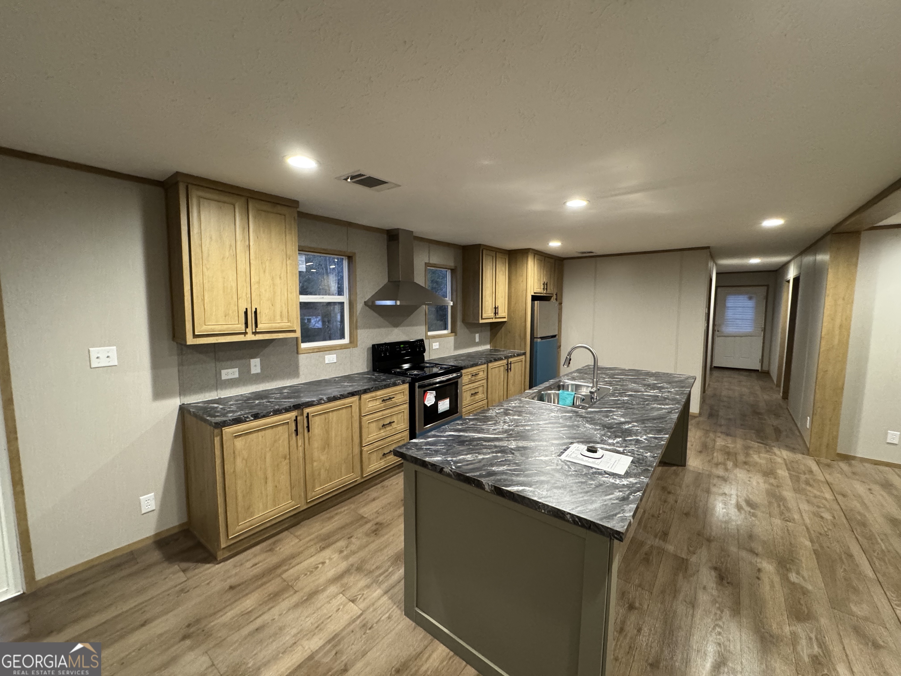 215 Poplar Circle West Point, GA 31833 - Photo 7 of 15 a kitchen with stainless steel appliances granite countertop a sink and stove