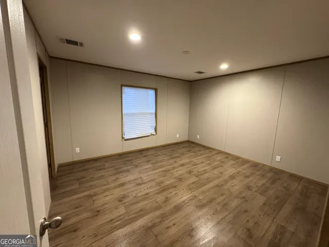 a bathroom with granite countertop a sink and a mirror