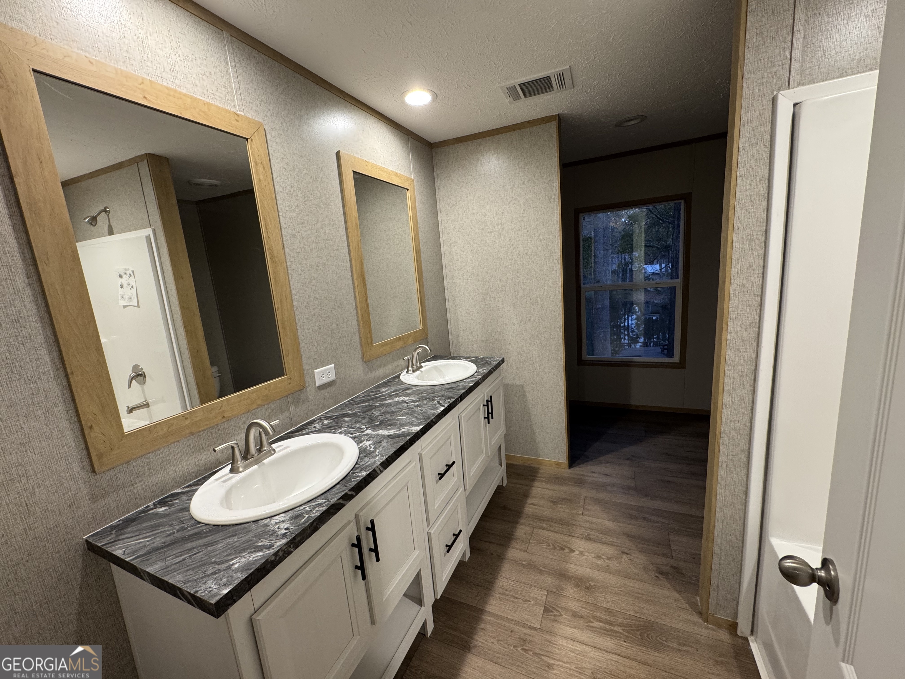 215 Poplar Circle West Point, GA 31833 - Photo 9 of 15 a bathroom with granite countertop a sink and a mirror