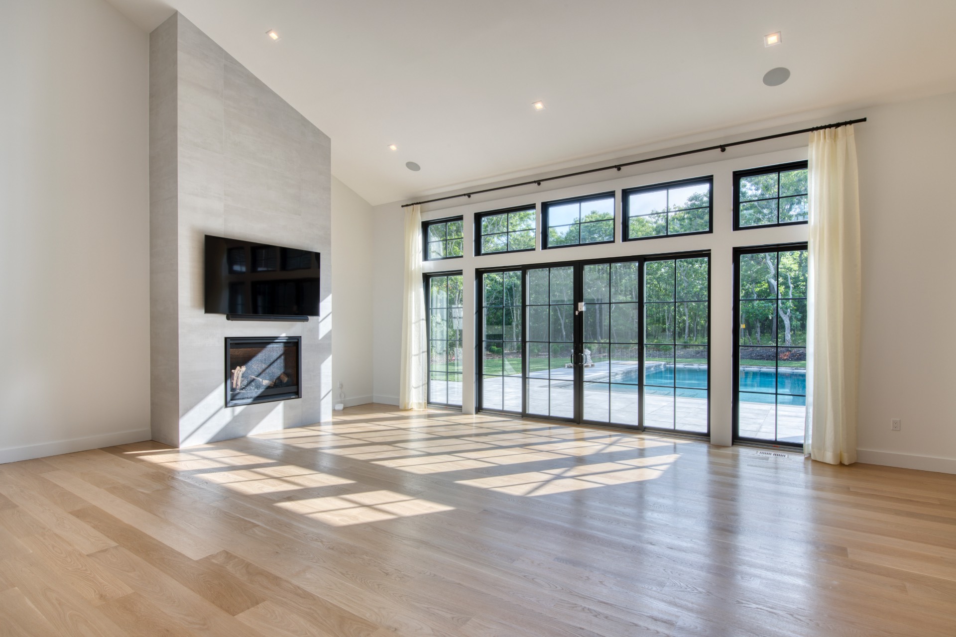497 Toppings Path Sag Harbor, NY 11963 - Photo 4 of 12 a view of an empty room with wooden floor and a window