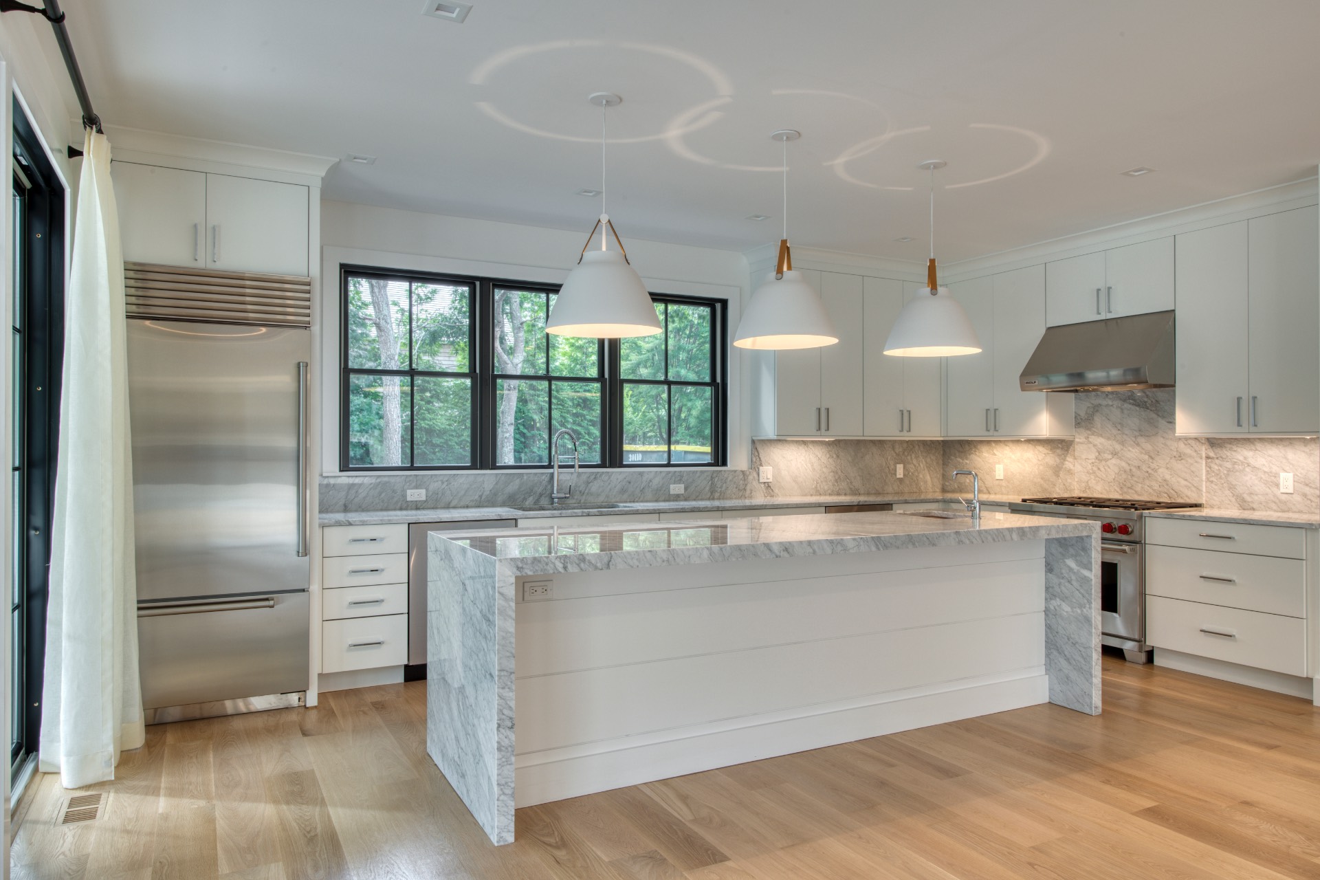 497 Toppings Path Sag Harbor, NY 11963 - Photo 5 of 12 a kitchen with kitchen island a counter top space a sink stainless steel appliances and cabinets