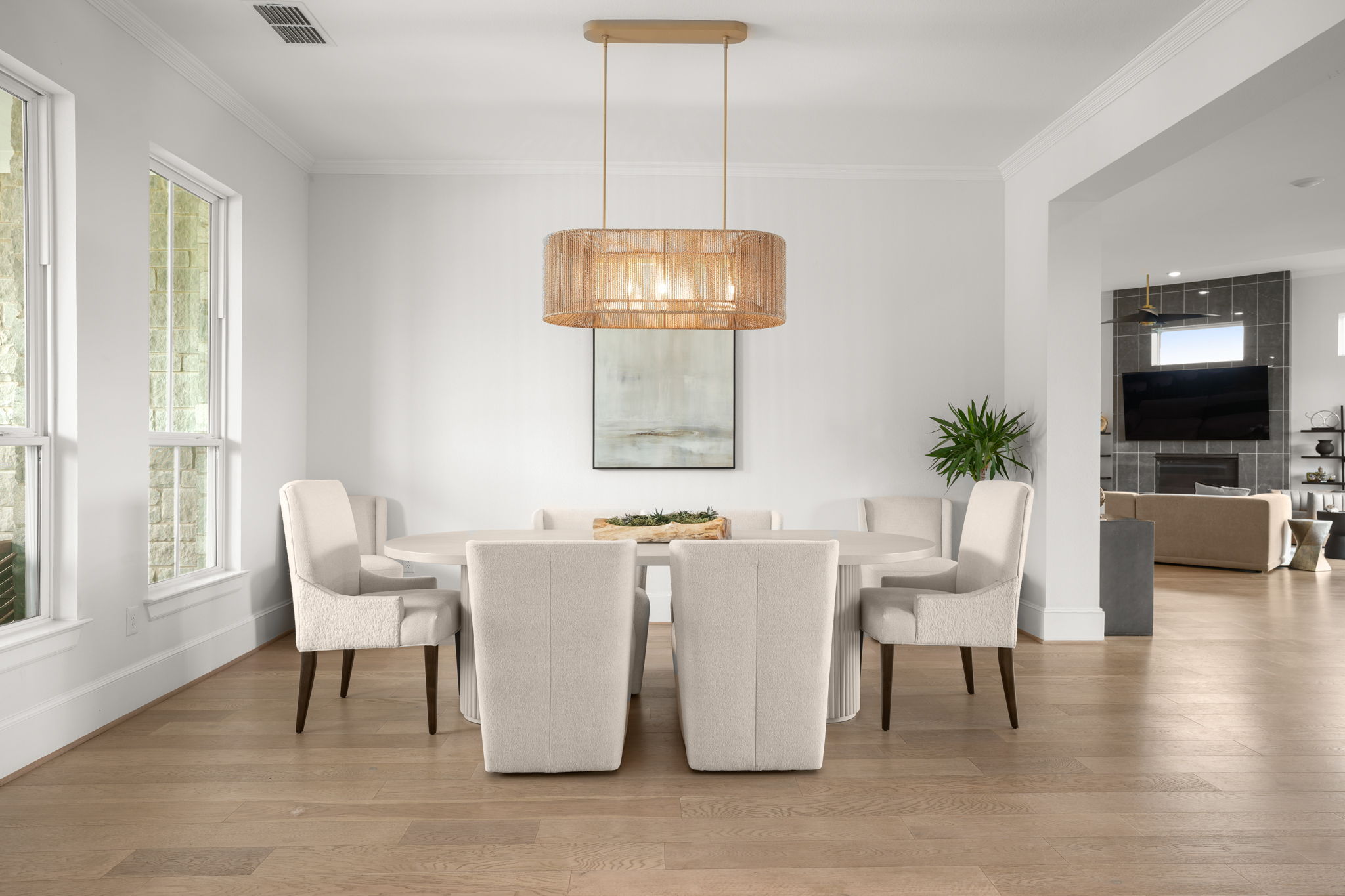 104 Lodestone Cove Austin, TX 78738 - Photo 9 of 40 This naturally illuminated dining space boasts high ceilings and rich hardwood flooring, offering an inviting atmosphere for gatherings.