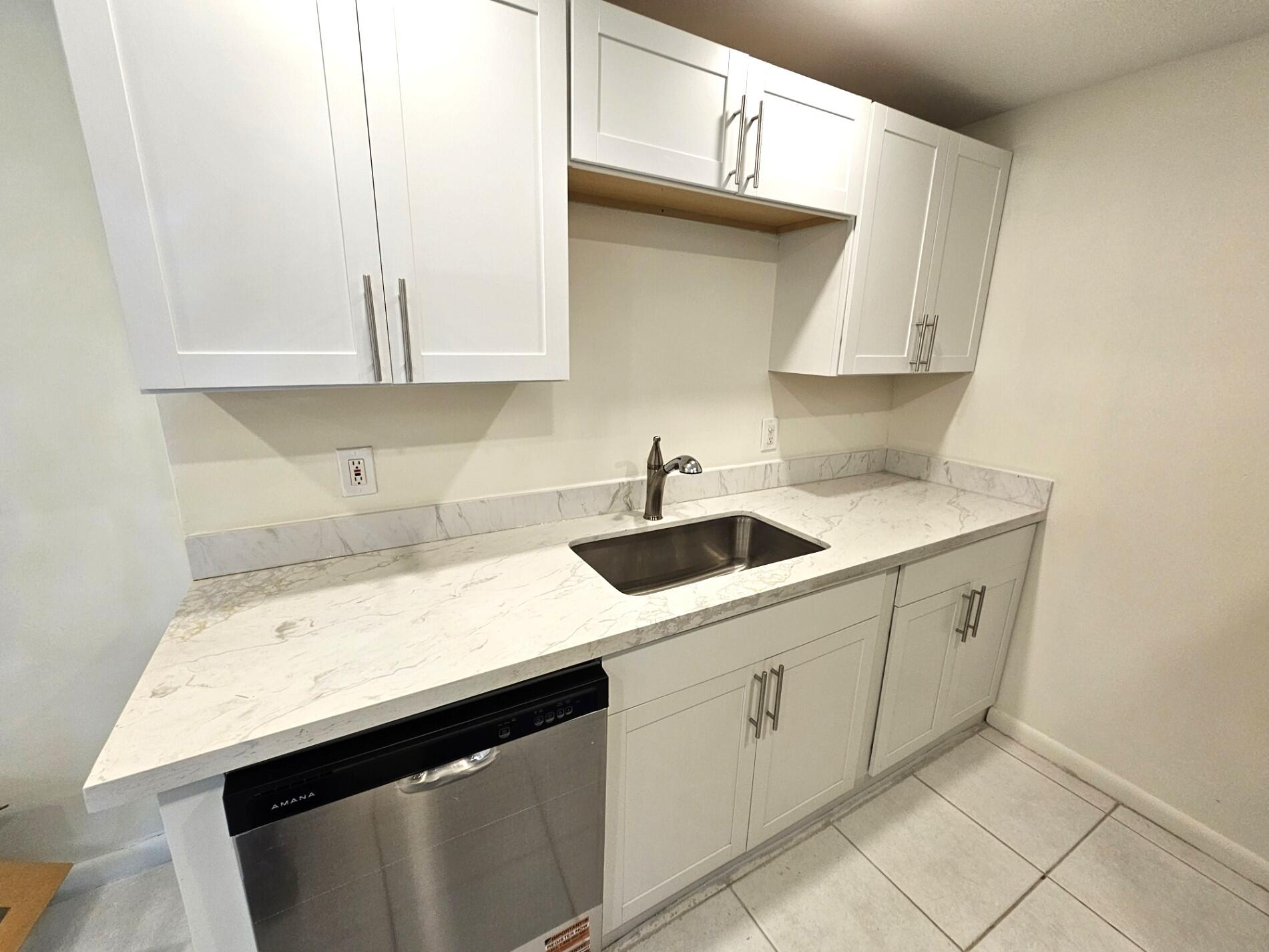1059 Ainslie Drive, Unit 1059 Boca Raton, FL 33434 - Photo 11 of 15 a kitchen with a sink dishwasher and cabinets