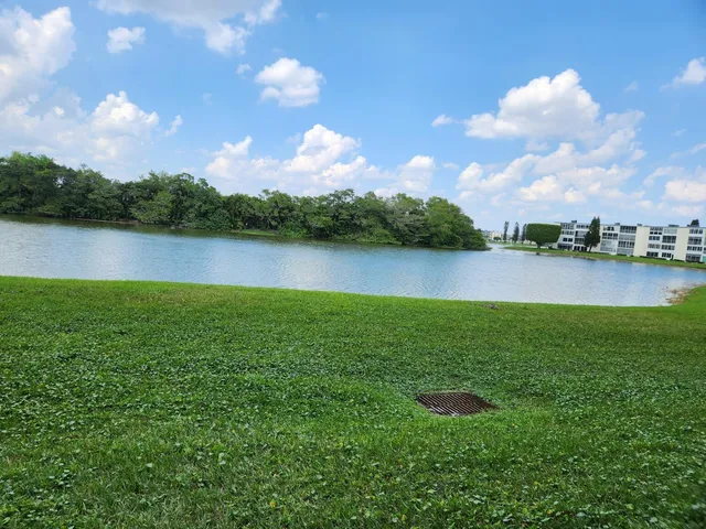 a view of a lake with houses in the back