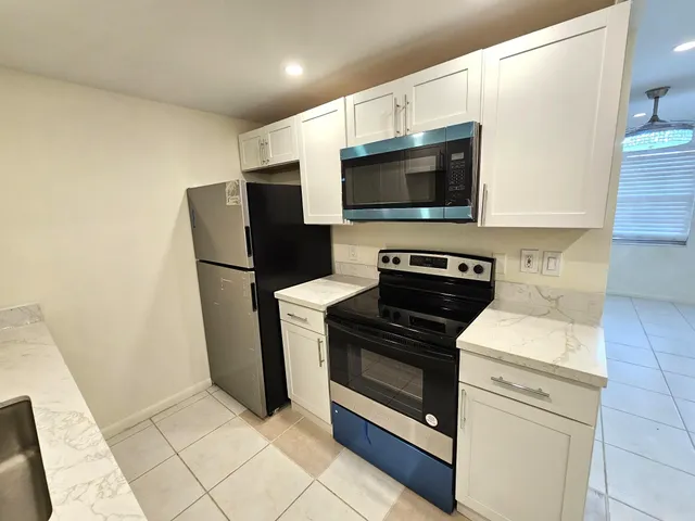 a kitchen with a refrigerator stove and microwave