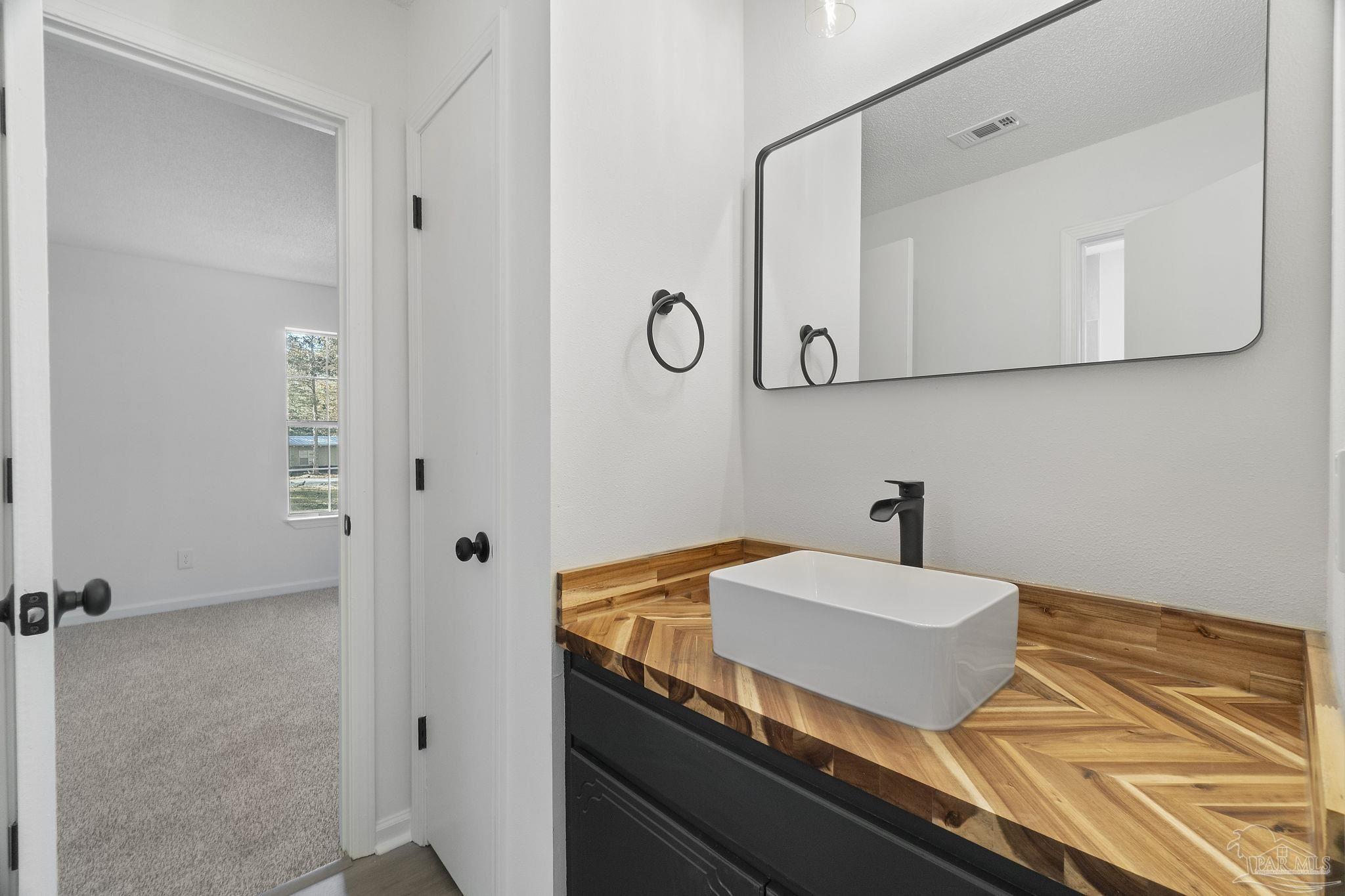 195 Miller Road DeFuniak Springs, FL 32435 - Photo 14 of 50 a bathroom with a sink and a mirror