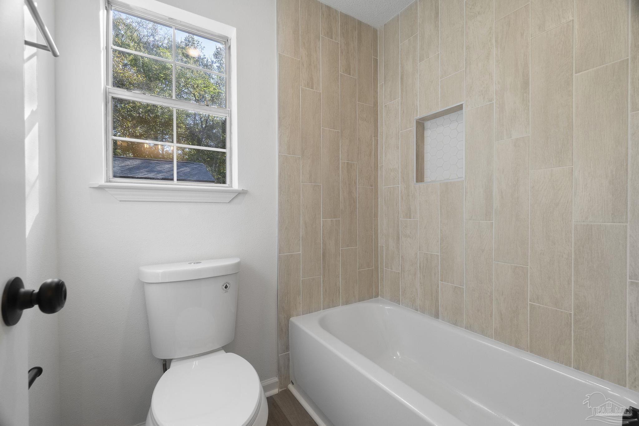 195 Miller Road DeFuniak Springs, FL 32435 - Photo 15 of 50 a white toilet sitting next to a bath tub