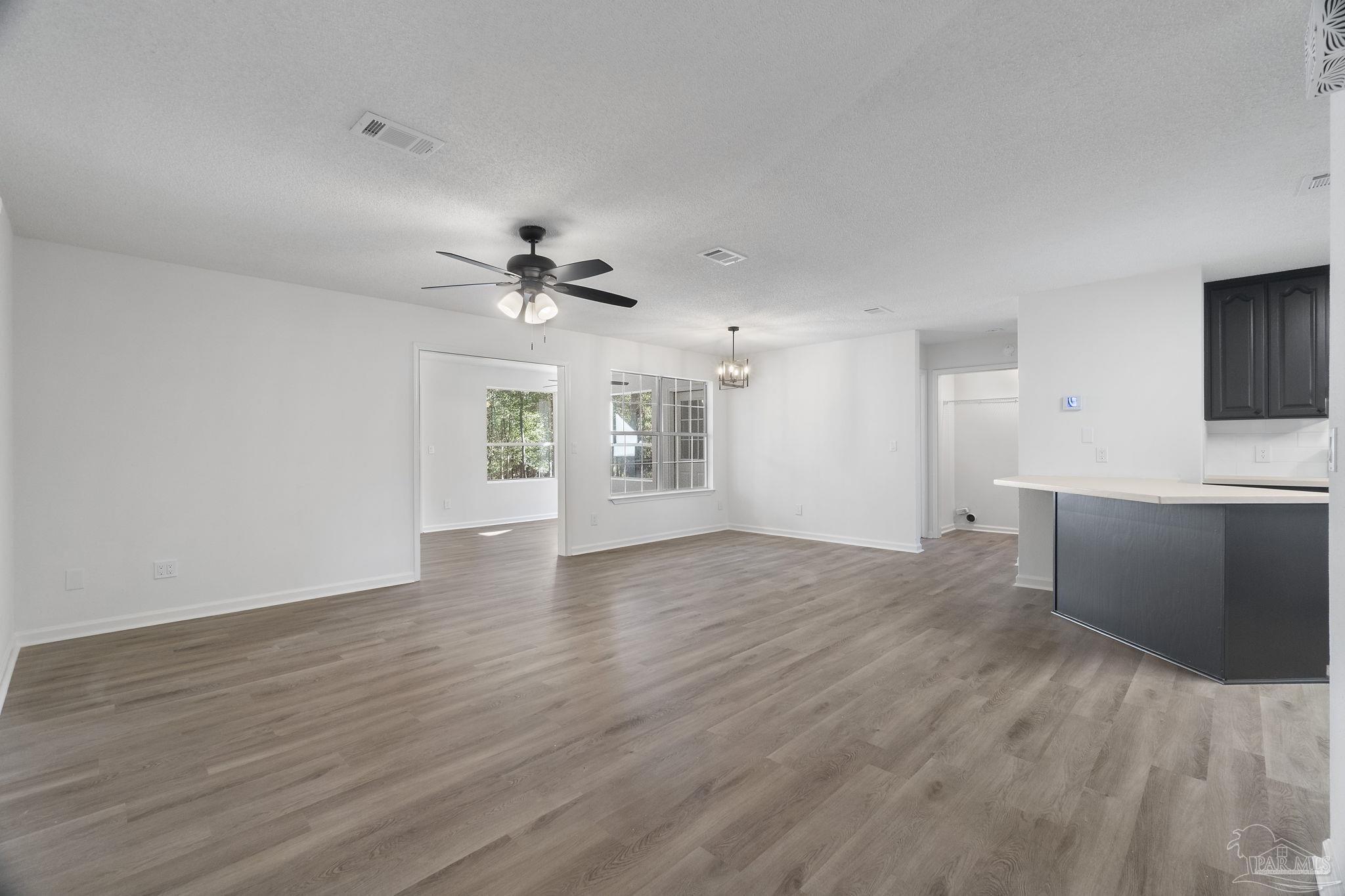 195 Miller Road DeFuniak Springs, FL 32435 - Photo 16 of 50 a view of an empty room with window and wooden floor