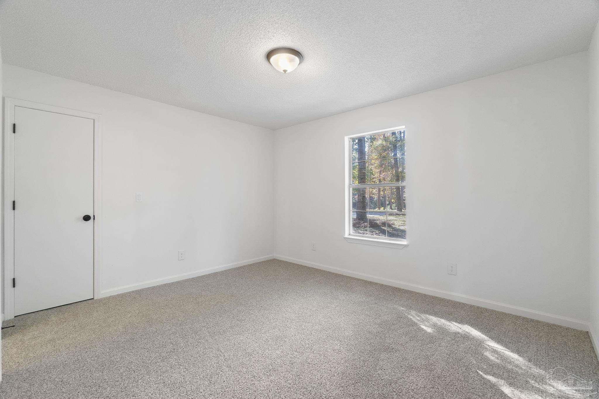 195 Miller Road DeFuniak Springs, FL 32435 - Photo 22 of 50 a view of an empty room with a window