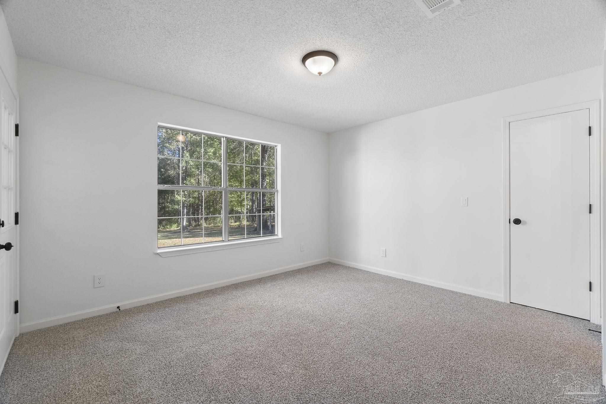 195 Miller Road DeFuniak Springs, FL 32435 - Photo 25 of 50 a view of an empty room with a window