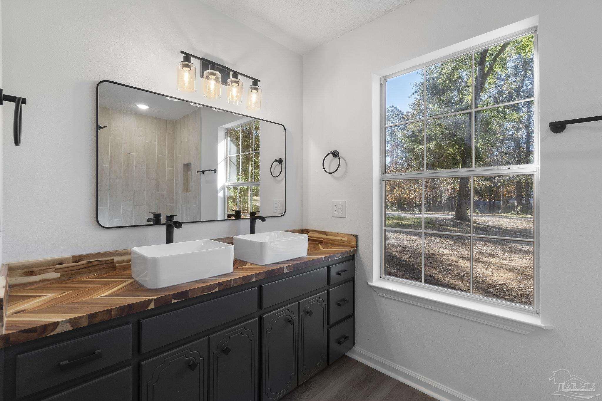 195 Miller Road DeFuniak Springs, FL 32435 - Photo 29 of 50 a bathroom with double vanity and a mirror