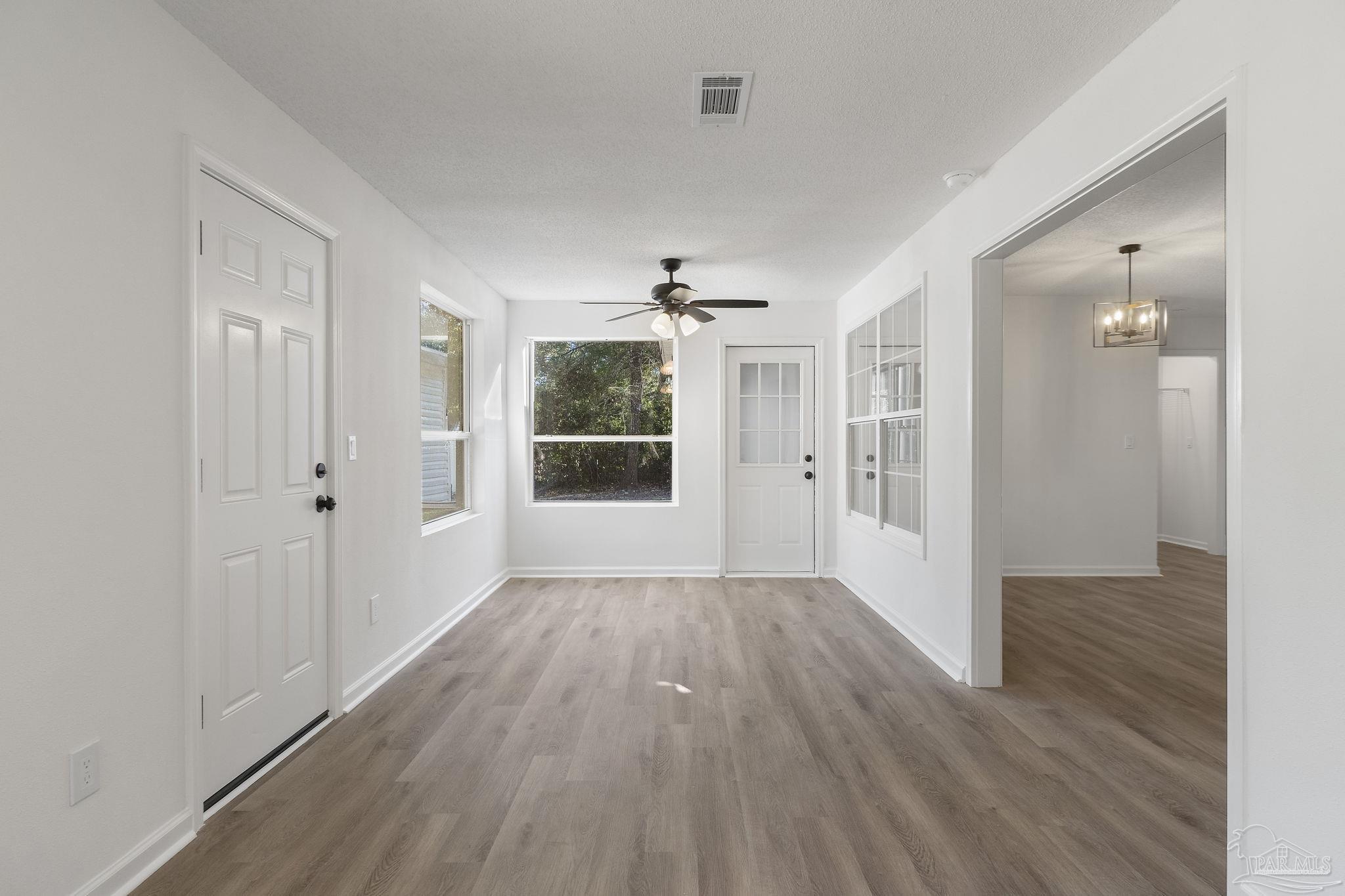 195 Miller Road DeFuniak Springs, FL 32435 - Photo 31 of 50 wooden floor in an empty room with a window