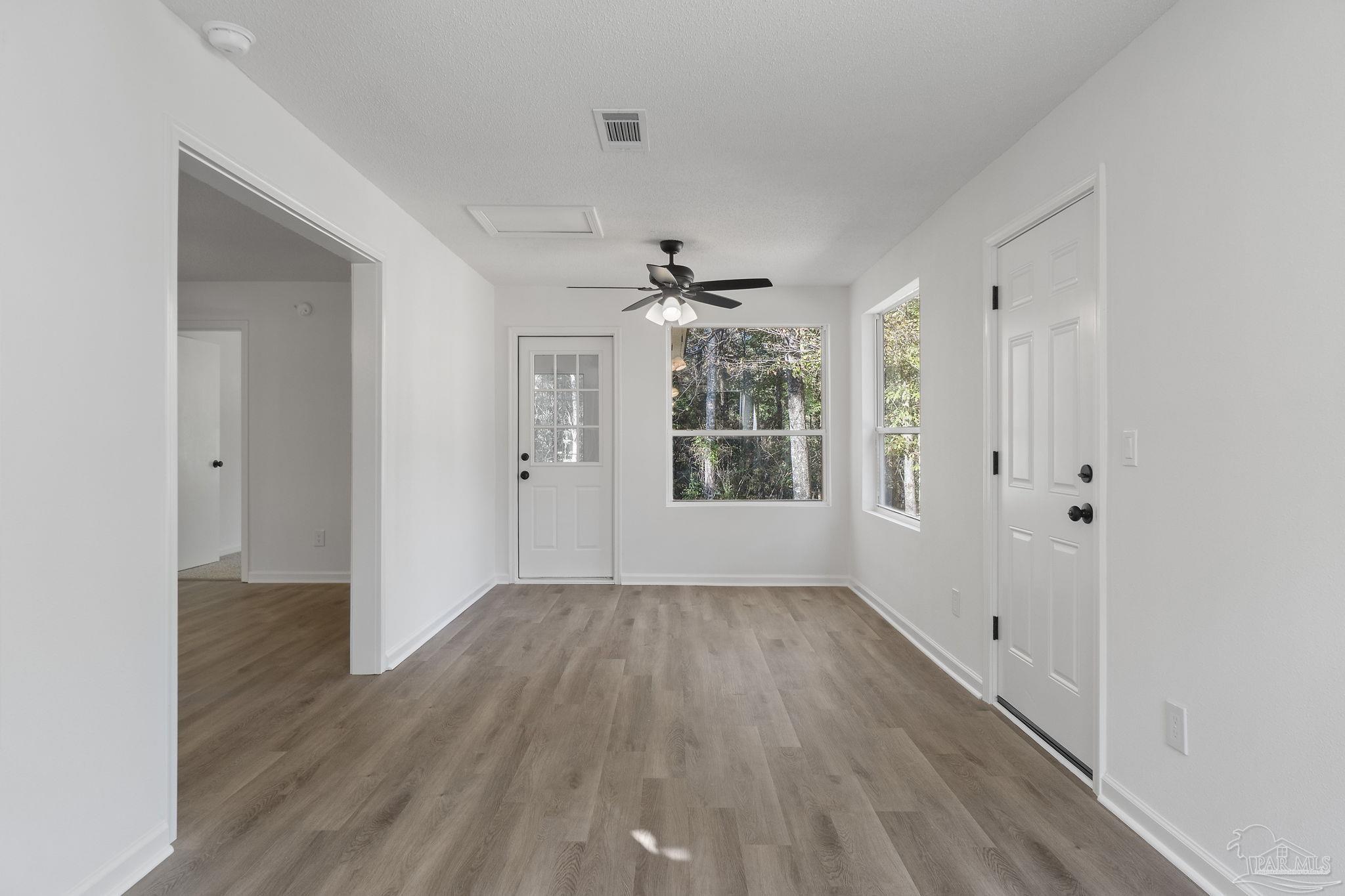 195 Miller Road DeFuniak Springs, FL 32435 - Photo 32 of 50 wooden floor in an empty room with a window