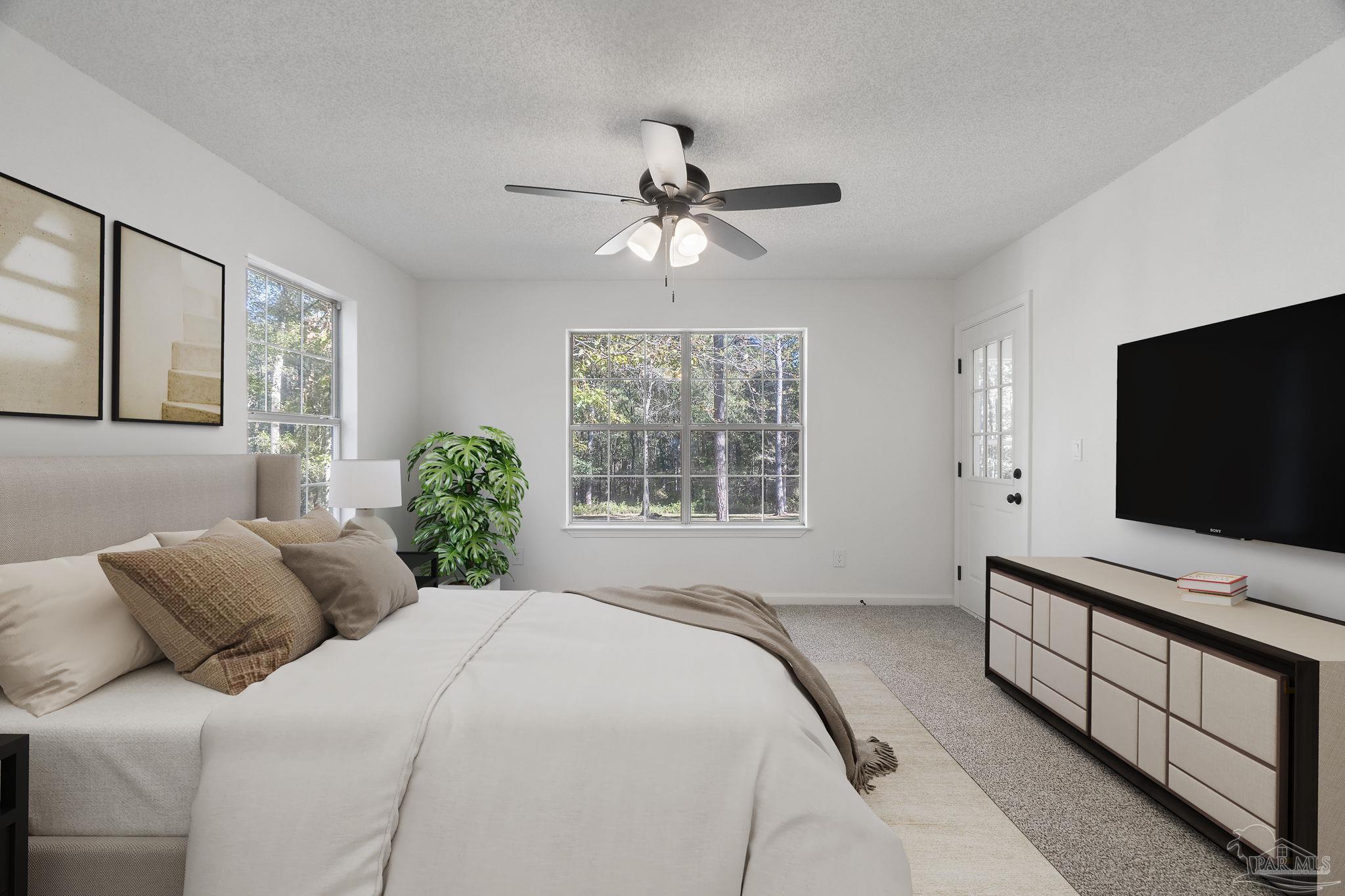 195 Miller Road DeFuniak Springs, FL 32435 - Photo 6 of 50 a bedroom with a bed and a flat screen tv