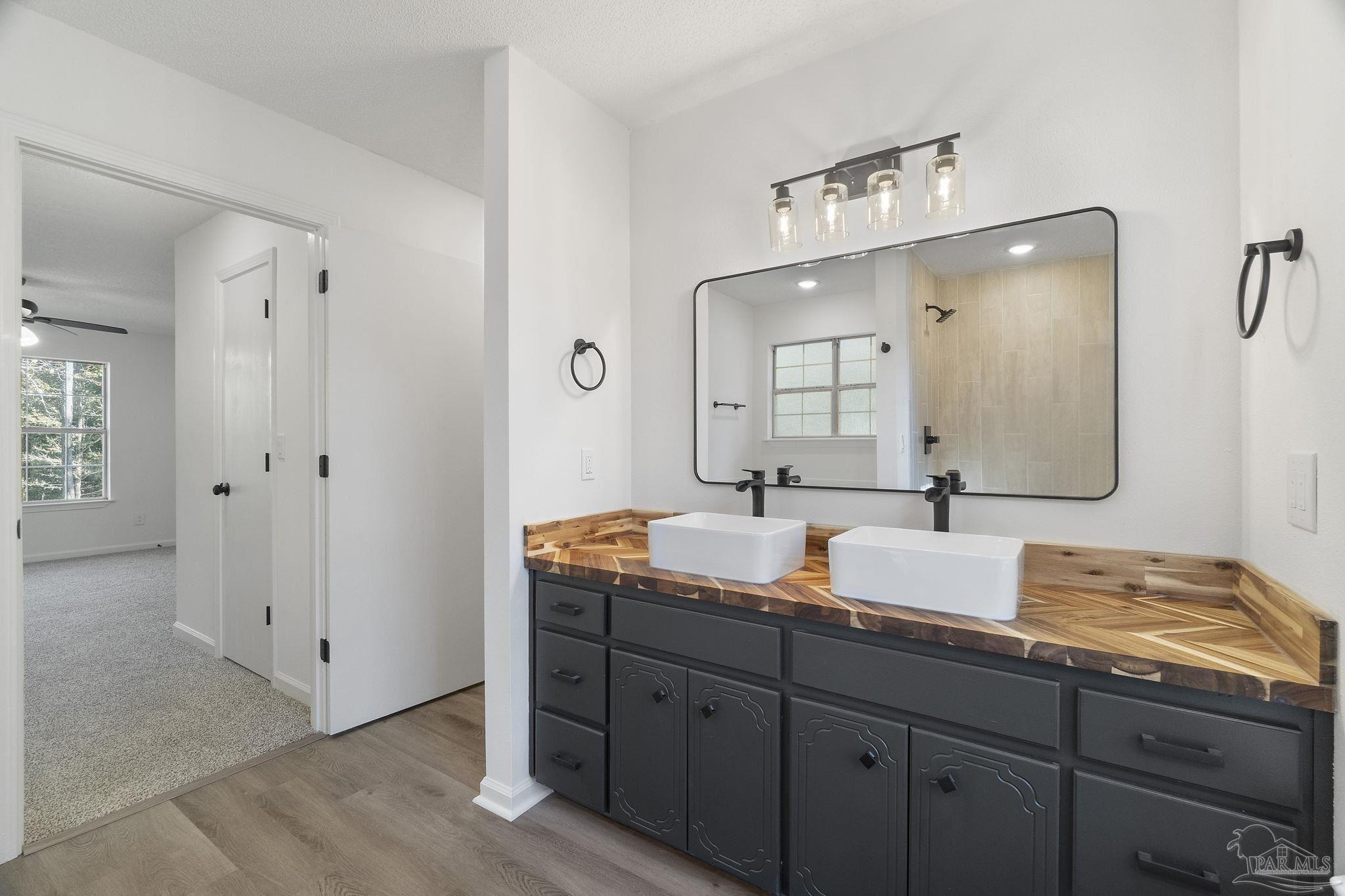 195 Miller Road DeFuniak Springs, FL 32435 - Photo 7 of 50 a bathroom with double vanity sinks and a mirror