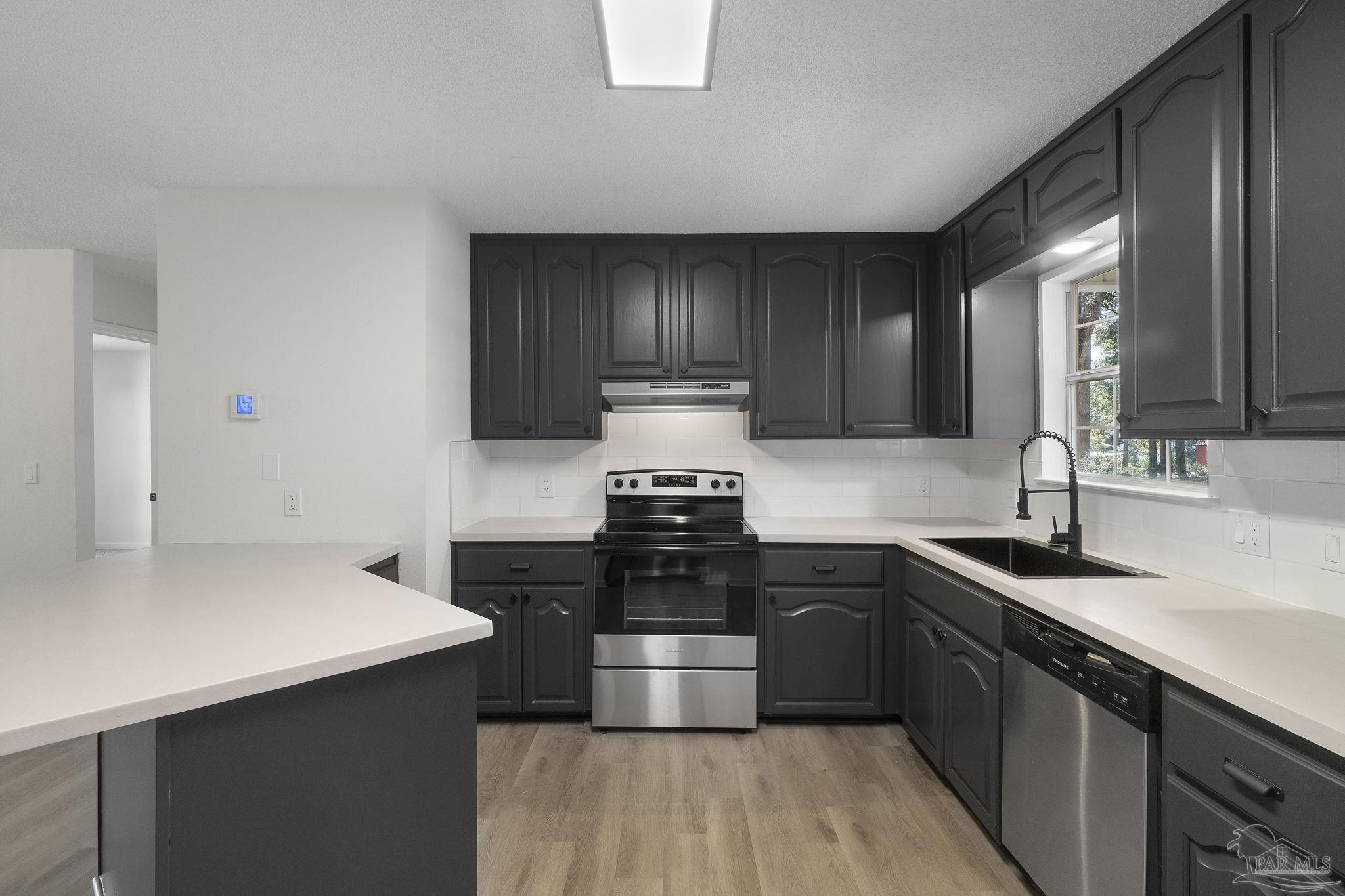 195 Miller Road DeFuniak Springs, FL 32435 - Photo 10 of 50 a kitchen with a sink and stove