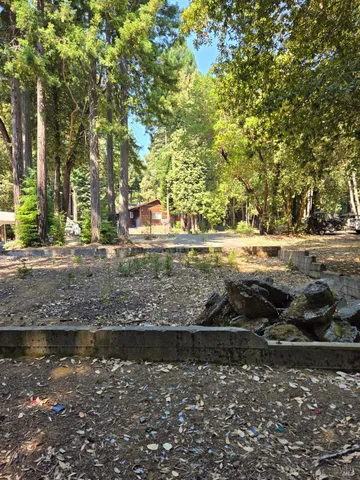 a view of a yard with wooden fence