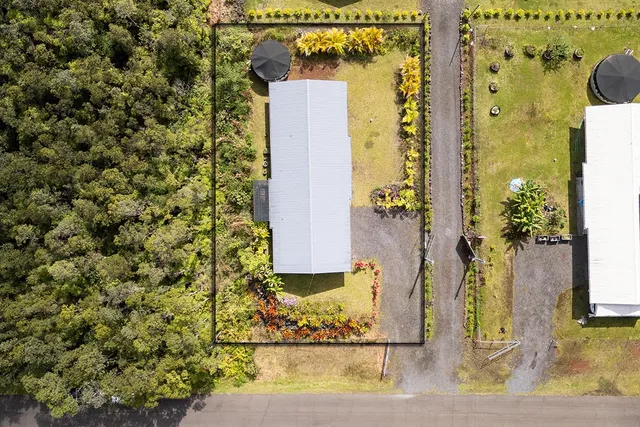 a front view of house with yard outdoor seating and barbeque oven