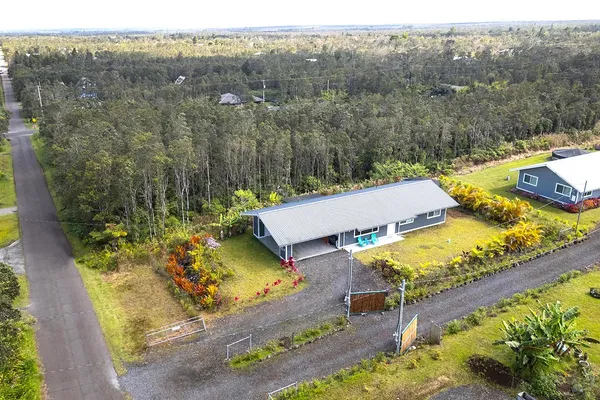 an aerial view of a house with a swimming pool