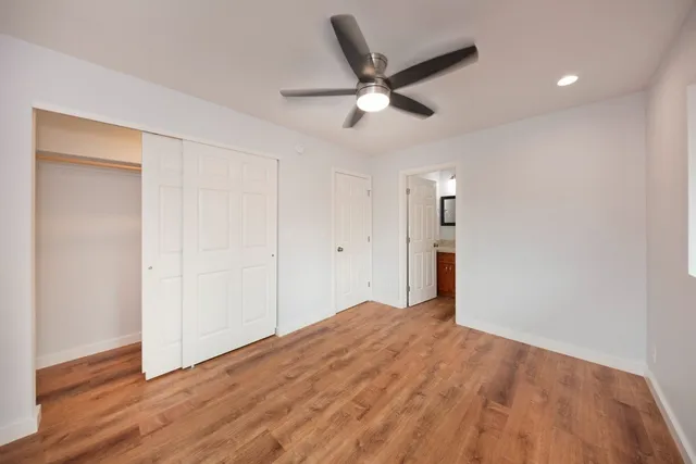 a view of empty room with wooden floor